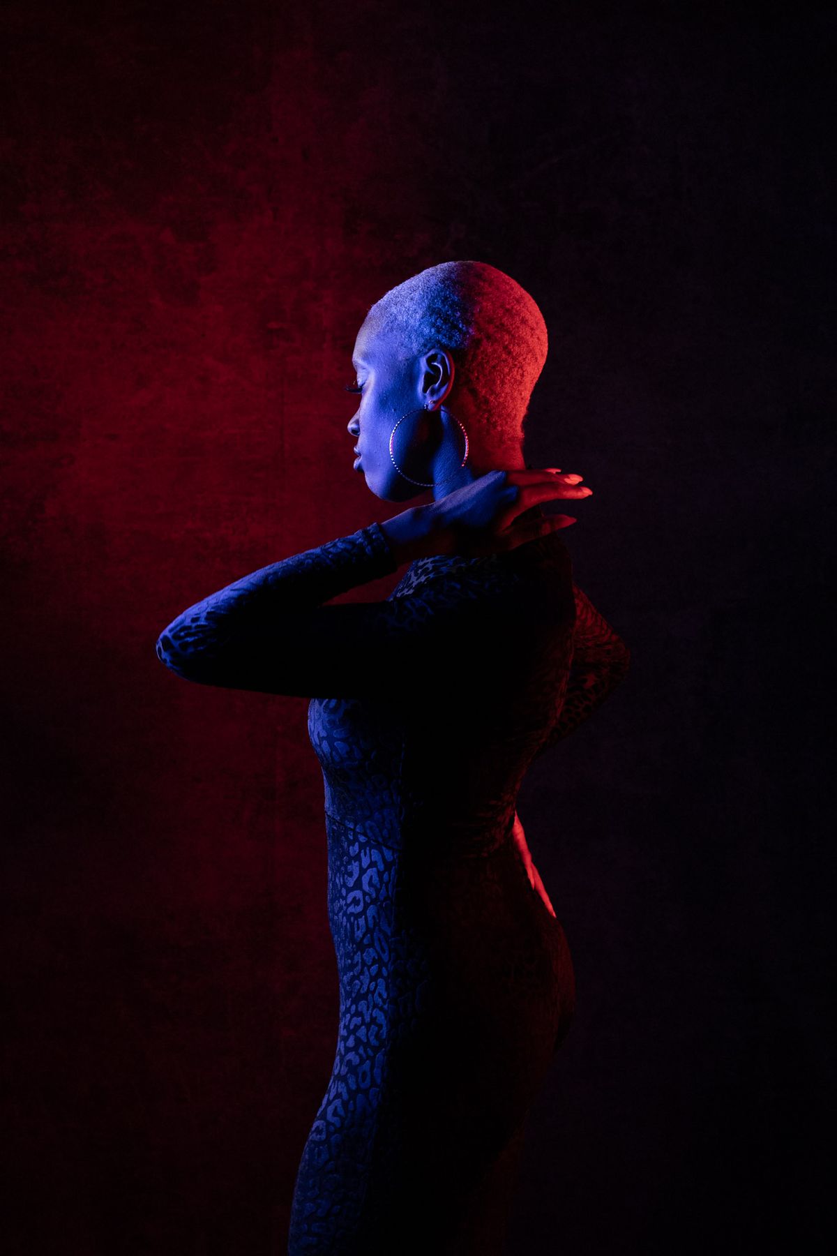 Dramatic red and blue lit profile portrait of a model